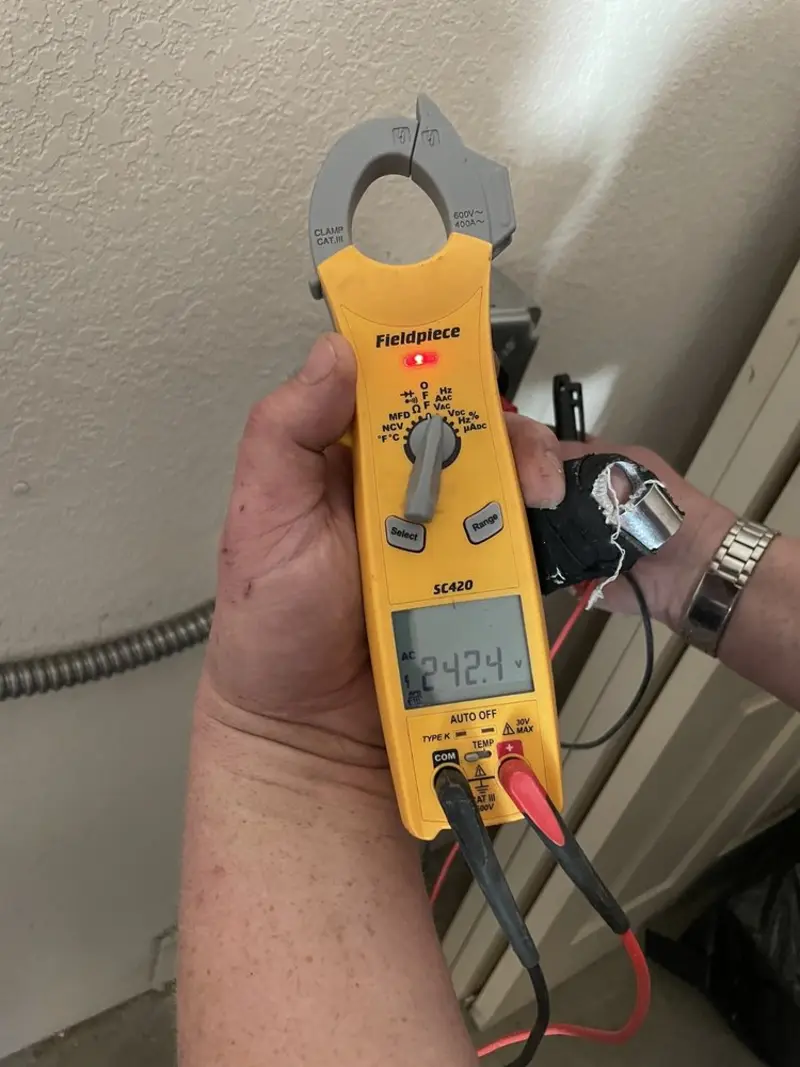 Voltage testing with clamp meter during Ceiling Fan Installation in Byram